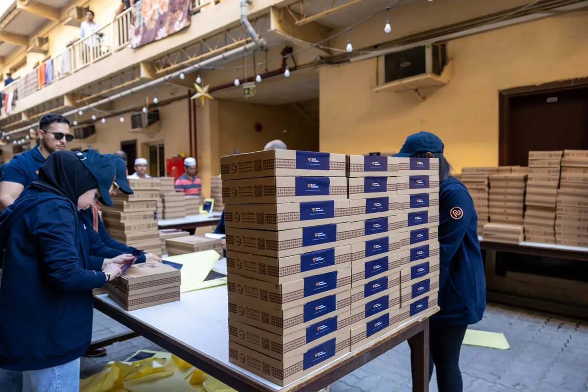 Worker securely packing Indian manufactured products for export