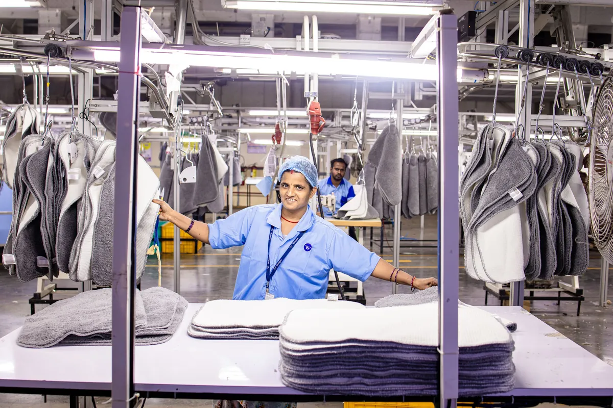 Factory worker checking product quality for export